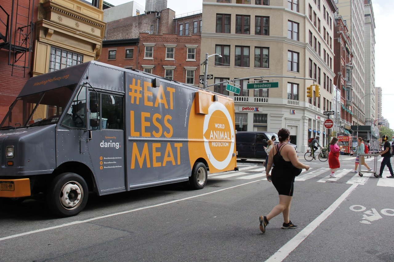 woman getting plant based chicken from WAP food truck