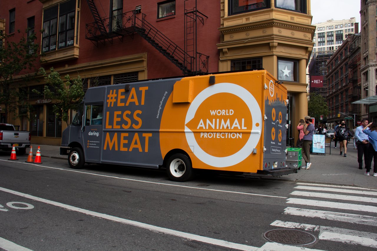 woman getting plant based chicken from WAP food truck