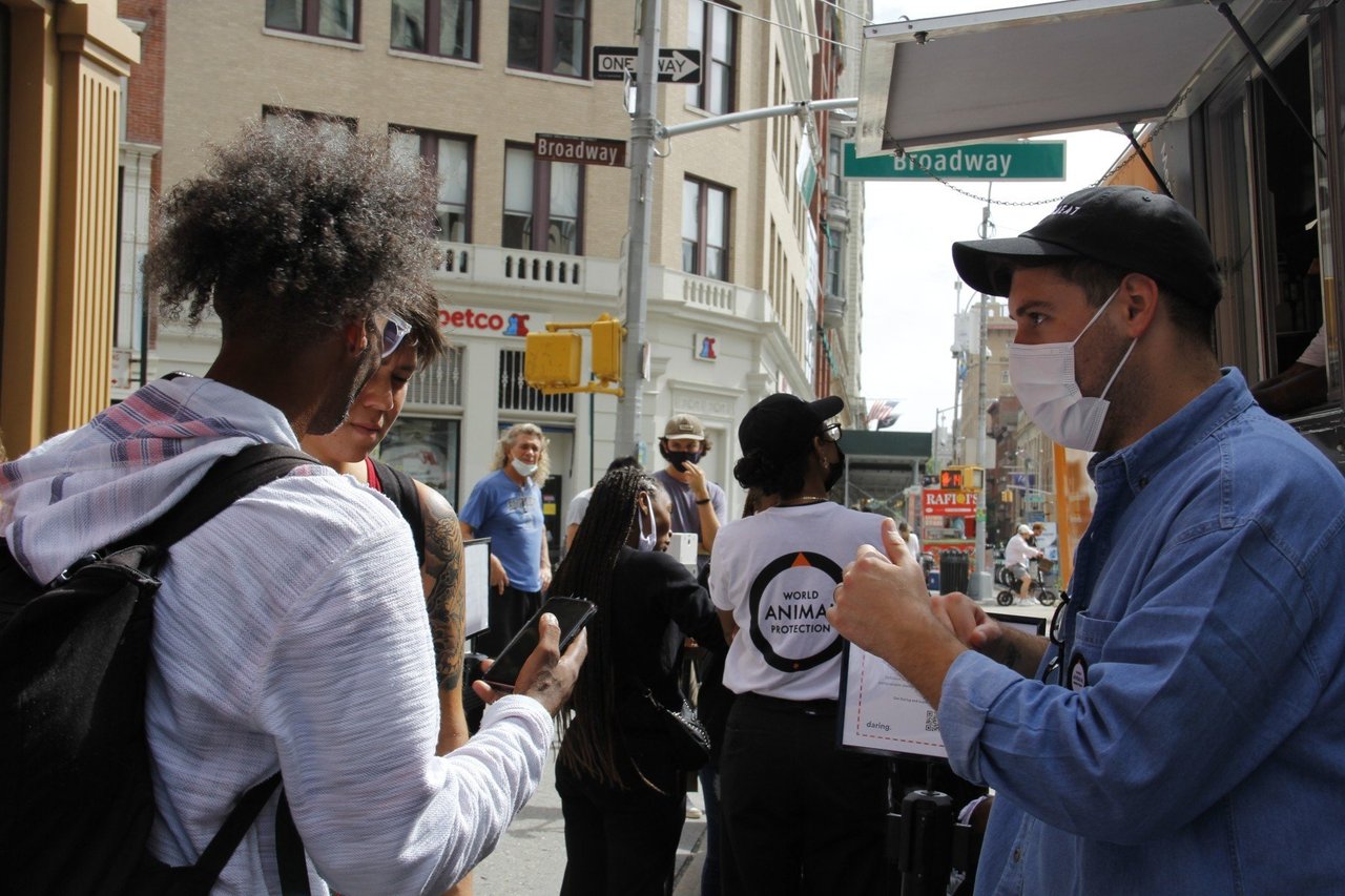 woman getting plant based chicken from WAP food truck