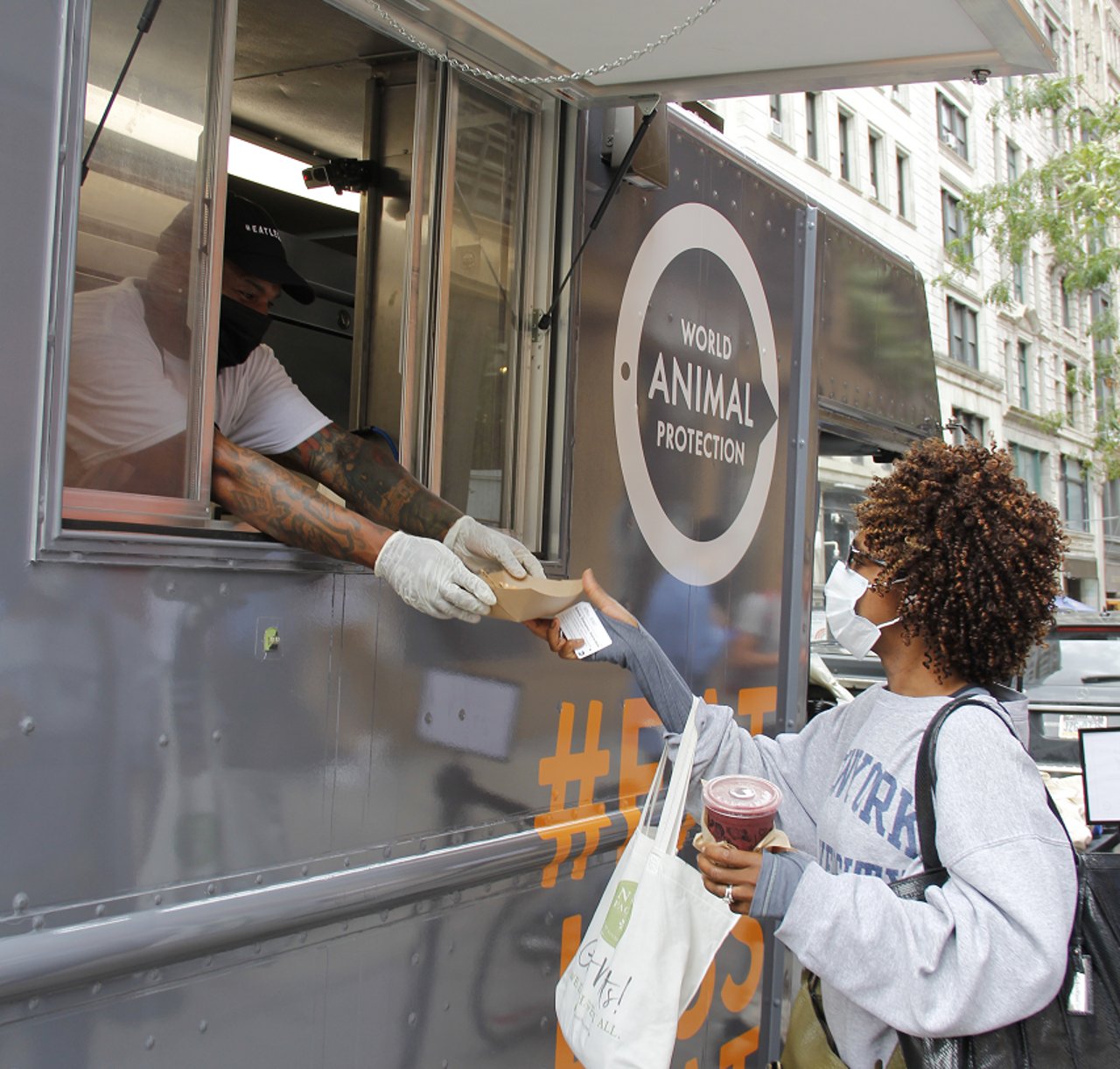 woman getting plant based chicken from WAP food truck