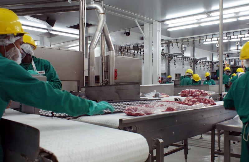 Workers at a meat processing plant