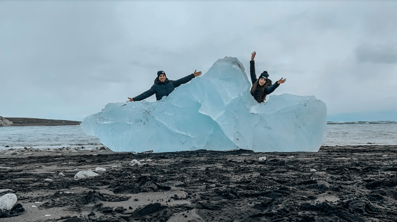 Jessica Salazar and her partner with a glacier in Iceland