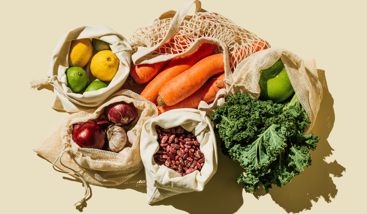 Grocery bags filled with plant foods.