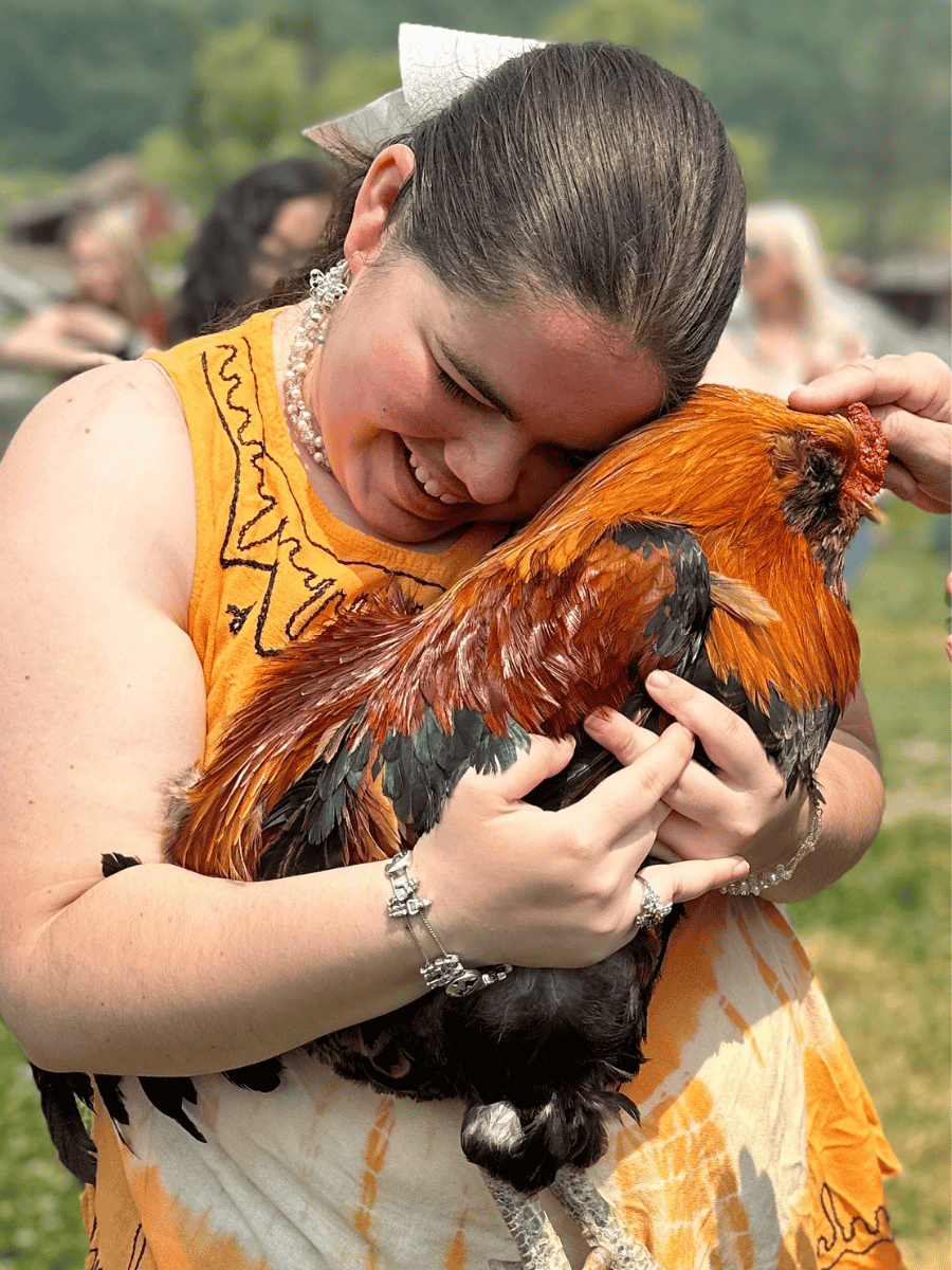Sid the rooster with a visitor at Tamerlaine Sanctuary & Preserve.
