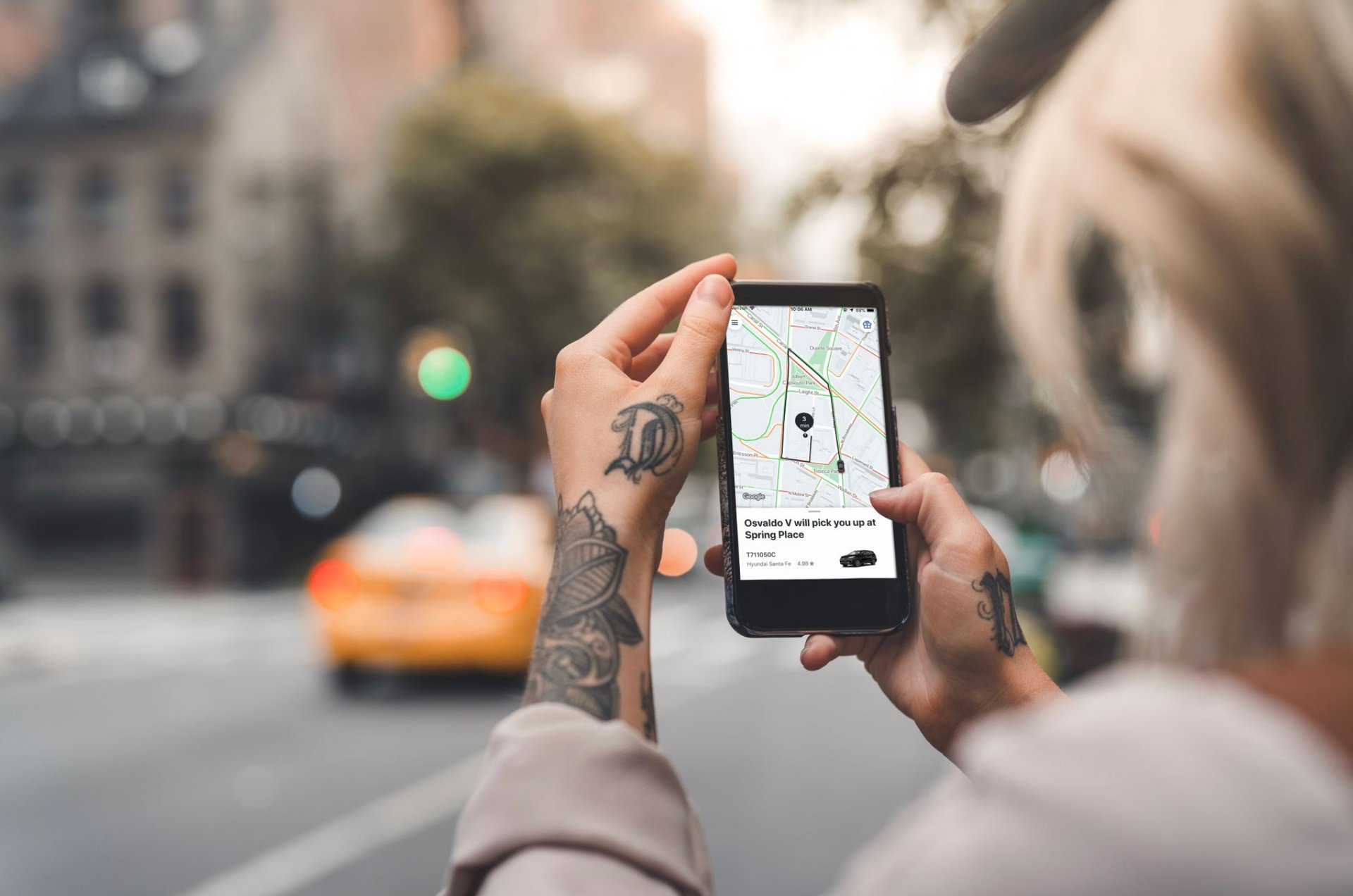 A person hailing a cab through a ride-sharing app.