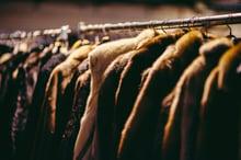 Fur coats hanging on a rack.