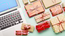 Gifts next to a laptop.