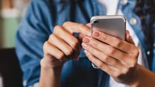 woman scrolling social media on her cell phone