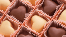 Heart-shaped Valentine's Day chocolates in a pink box.