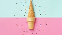 Two ice cream cones on a pink and blue background