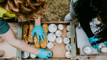 People packing canned goods for donation to a food bank.