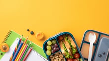 A generic school lunch and supply background.