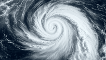A aerial view of a the eye of a hurricane in the middle of the ocean.