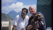John Walsh poses with a dog and friend.
