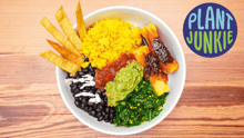 A bowl of plant-based food from Plant Junkie with the company’s logo at the right top of the image.