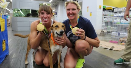 Athena the dog with two Olympic gold medallists at our dog adoption event in Rio