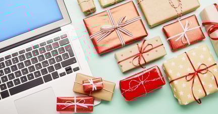 Gifts next to a laptop.