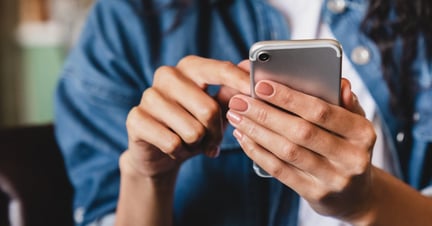 woman scrolling social media on her cell phone
