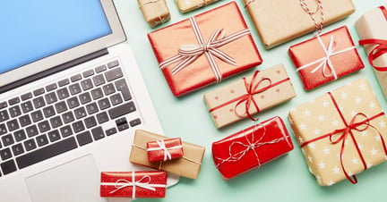 Gifts next to a laptop.