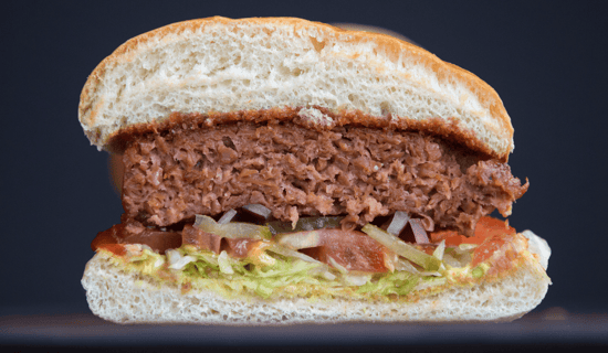 A vegan burger cut in half down the middle.
