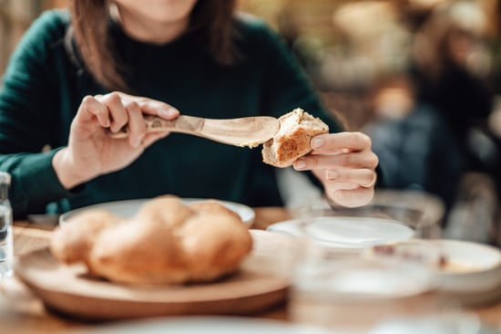 Spreading vegan butter on bread.