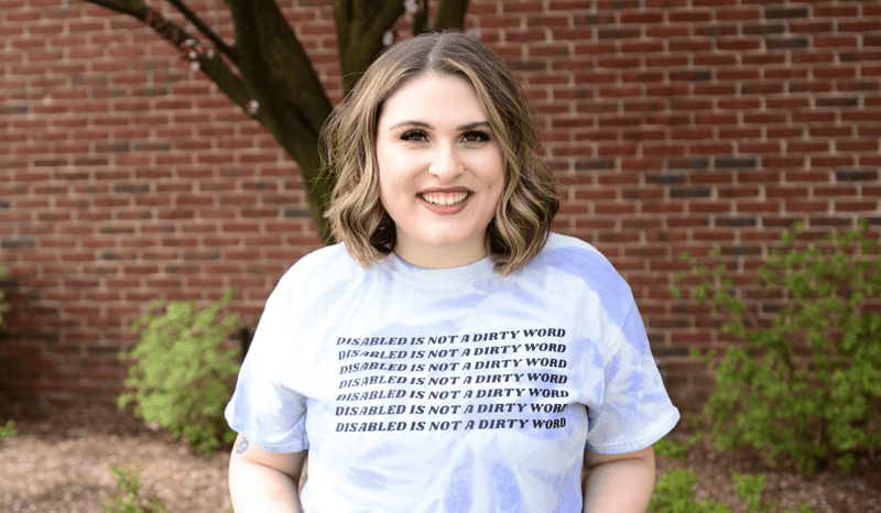 WAP team member Kara King wearing a T-shirt that says "disabled is not a dirty word."