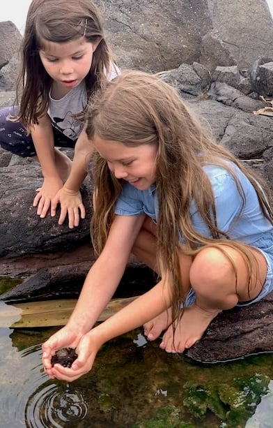 Maia and her younger sister finding tadpoles.